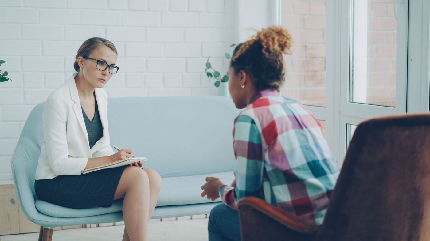 A clinician and a patient talking during a consultation